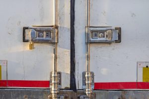 Close-up of secure locks on a truck's rear doors, illustrating measures to prevent cargo theft.