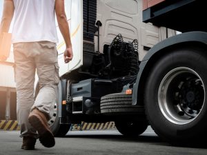 Driver approaching an hc vehicle truck, illustrating the preparation for heavy vehicle operation.