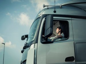 Truck driver operating a vehicle, illustrating skills gained with an LR class licence.