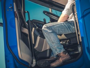 Driver sitting in a truck preparing for an LR class licence practical test.