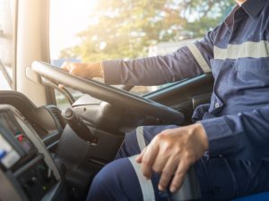 A middle-aged man driving a large truck, highlighting the truck licence age limit in Australia.