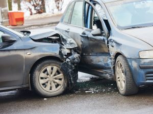 Two cars involved in a collision, highlighting the importance of responsible driving for a light rigid licence.