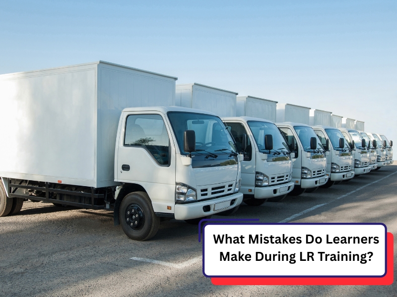 Fleet of white trucks lined up for lr training assessment at a professional driving school.