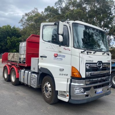 Heavy rigid Hino training truck used by Core Driving School for HR Licence instruction in NSW.